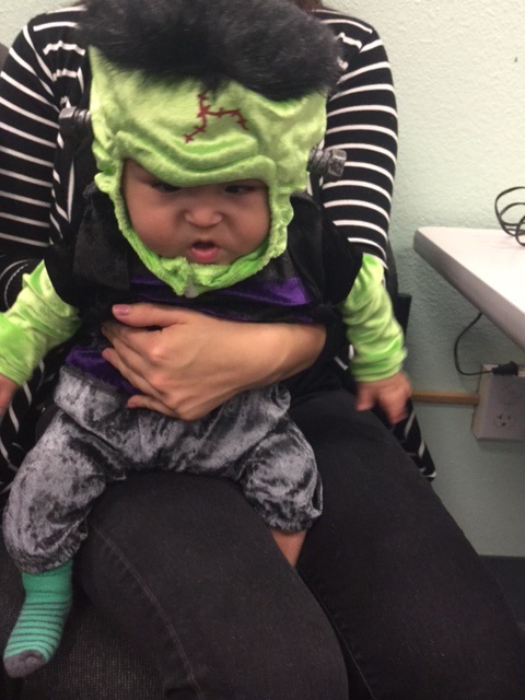 A baby dressed as Frankenstein. 